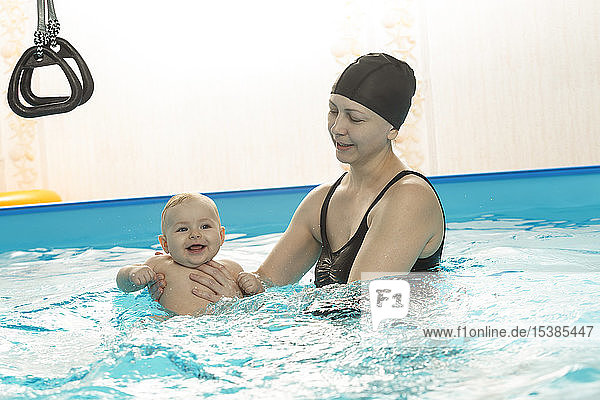 Baby swimming  mother with daughter in swimming pool