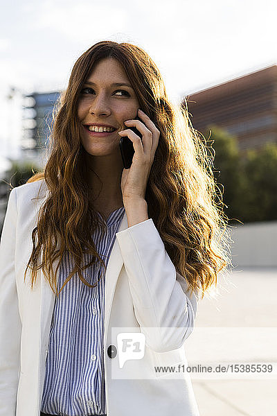 Young businesswoman in the city  talking on the phone