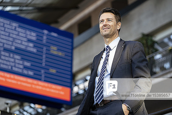 Smiling businessman at the station