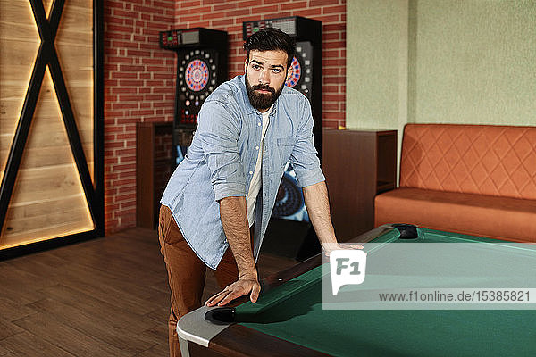 Portrait of man at billiard table