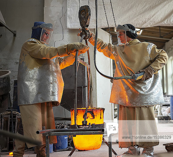 Art foundry  Foundry workers lifting mold