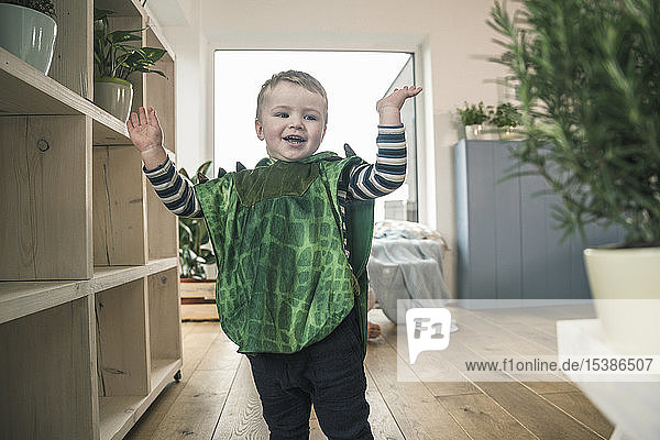Happy boy in a costume at home