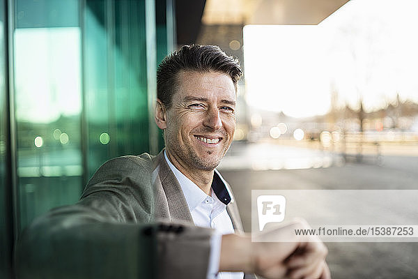 Portrait of smiling businessman outside a building in the city