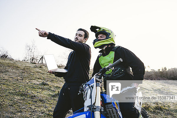 Motocross with coach pointing his finger