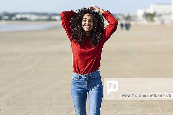 Portrait of happy young woman on the beach