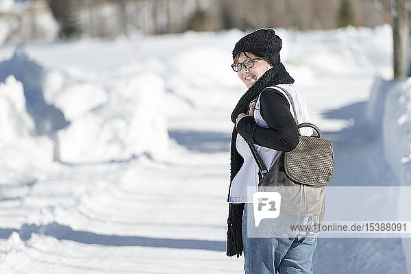 Portrait of smiling woman with backpack on a winter walk