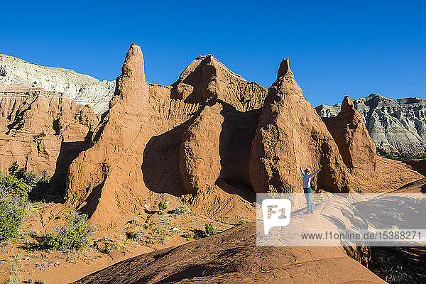 USA  Utah  Frau steht vor roten Sandsteinformationen im Kodakchrome Basin State Park