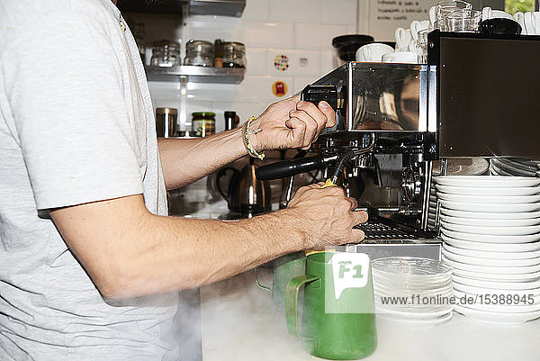 Close-up of barista preparing coffee