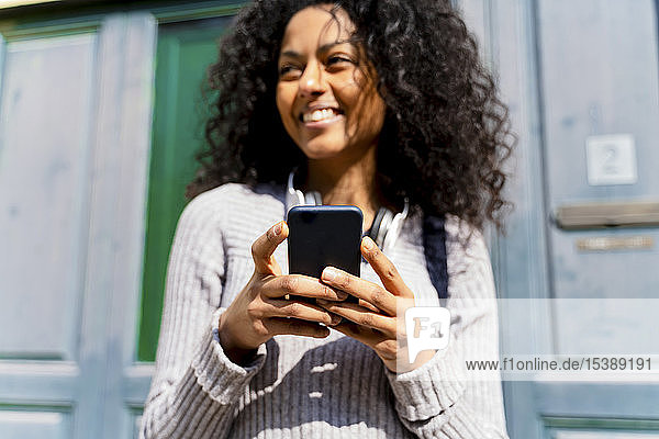 Laughing woman holding smartphone