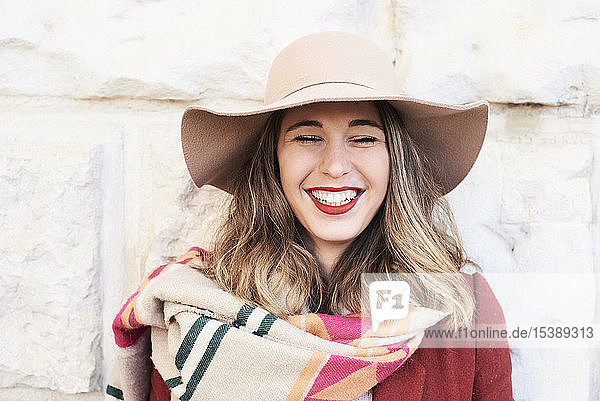 Portrait of a happy stylish woman wearing a floppy hat