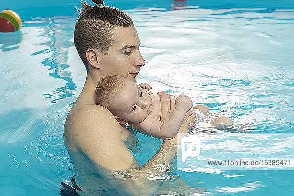 Baby swimming  father and son in swimming pool