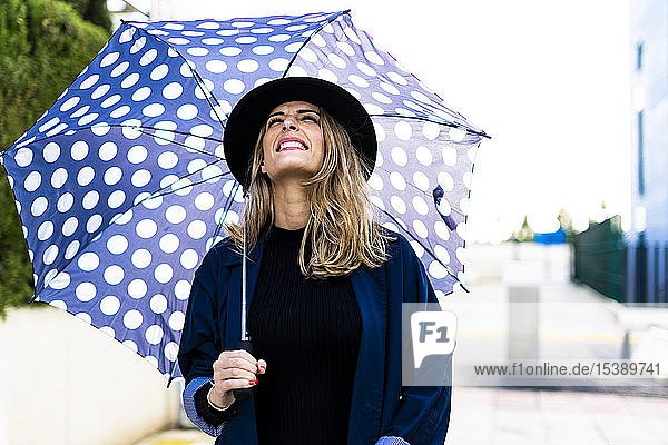 Blond woman with umbrella on a rainy day