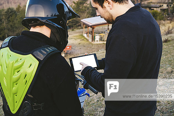 Motocross im Gespräch mit dem Trainer mit Tablet