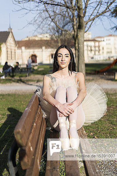 Italy  Verona  portrait of ballerina sitting on bench in the city