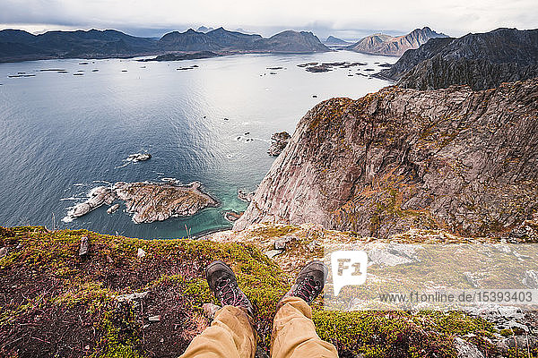 Norway  Lofoten Islands  Henningsvaer  hiker sitting on viewing point
