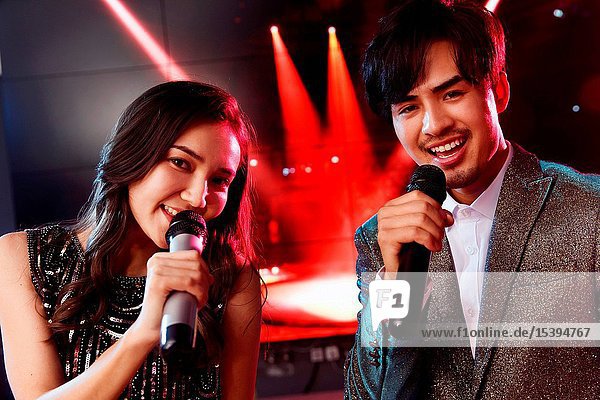 Happy young people singing and dancing