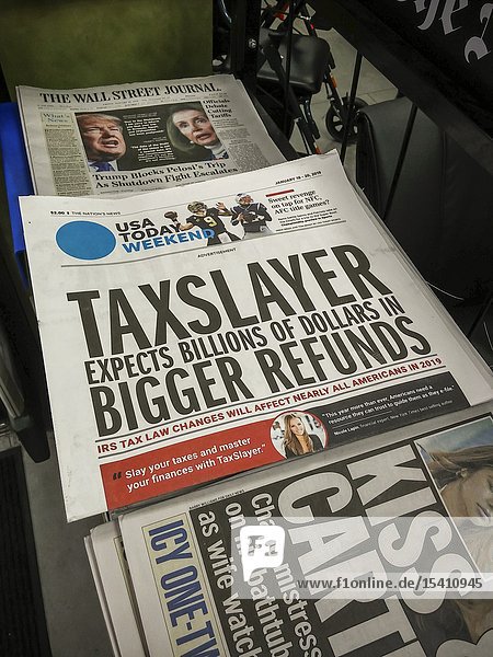 The weekend edition of USA Today featuring a wrap-around advertisement on its cover on a newsstand in New York on Friday January 18 2019. MNG Enterprises controled by hedge fund Alden Global Capital is reported to be preparing a slate of candidates to run for the board of Gannett assuming that Gannett rejects MNG's $1. 36 billion offer. (© Richard B. Levine).