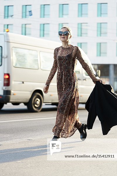 Fashionable woman walking at street in city in Munich Germany