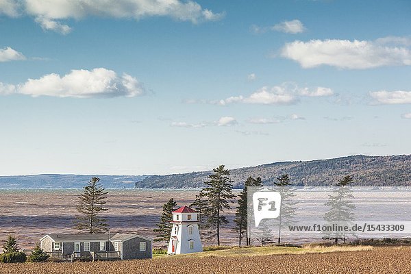 Canada Nova Scotia Blomidon Peninsula Scotts Bay seaside village with small lighthouse.