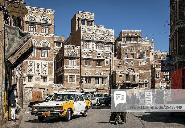 Street scene and local heritage architecture buildings in old town of sanaa yemen.