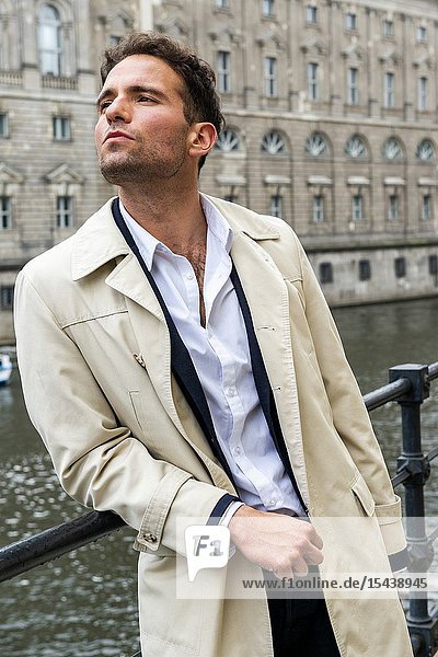 Berlin Germany. Gay business man strolling the streets of the German Capitol on his way to a his mobile workplace.