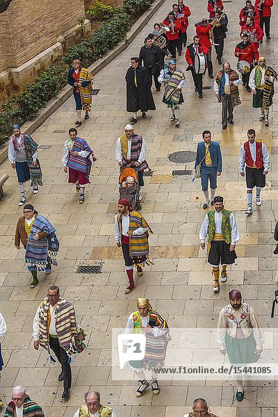 Falleros. Men in traditional dress. Parade to the Plaza de la Virgin in order to make an offering of flowers to Our Lady of the Forsaken the Patron Saint of Valencia. The celebration takes place from 4 pm until past nightfall. With all of the bunches of flowers given by the falleras to the Virgin an impressive 15 metre-high tapestry is formed on the main façade of the Basilica and a mantle is made for the Virgin. Fallas festival. Valencia. Valencian Community. Spain.
