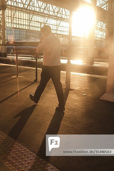 UK London Waterloo Station- commuter on the platform.