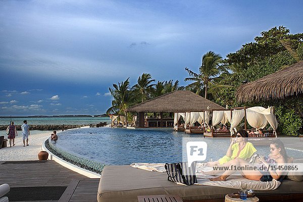 Swimming pool and restaurant in The Residence Hotel and Resort Gaafu Alifu Atoll. Maldives Islands.