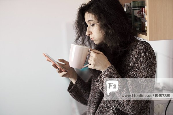 Young woman using smartphone in morning