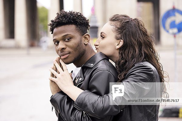 Young mixed race couple with folded hands at street in city in Munich Germany