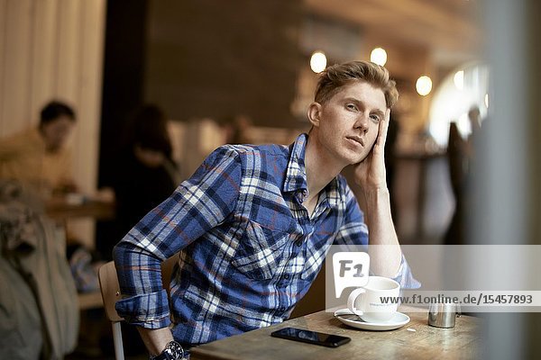 Young man sitting in coffee shop