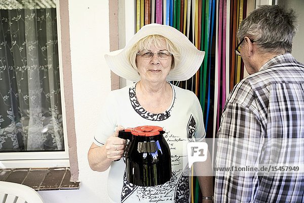 Senior woman with coffee pot ready for afternoon break