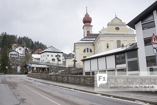 ORTISEI ITALY ON APRIL 14  2019: traditionally decorated houses and stores in the historic town center Gardena valley in Dolomites Sud Tirol Bolzano province Italy.