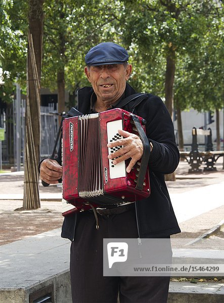 Man playing accordian at Cafe Francais Place Antonin Poncet Lyon France.