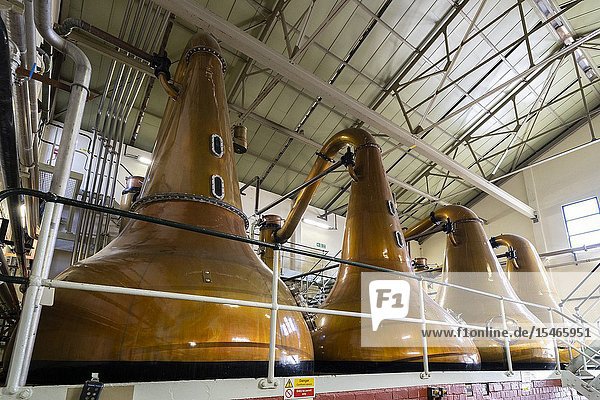 Stills inside still room Room at Lagavulin Distillery on island of Islay in Inner Hebrides of Scotland UK.