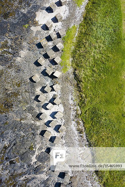 Aerial view of Second World War era anti-tank blocks on shore at Gosford Sands at Longiddry in East Lothian Scotland UK.