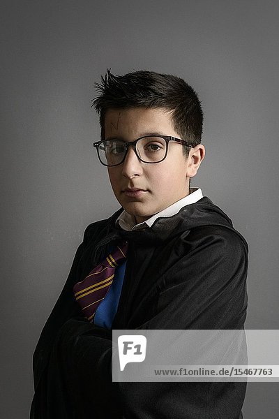 Caucasian schoolboy- 11 years old in Harry Potter party costume Studio shot.