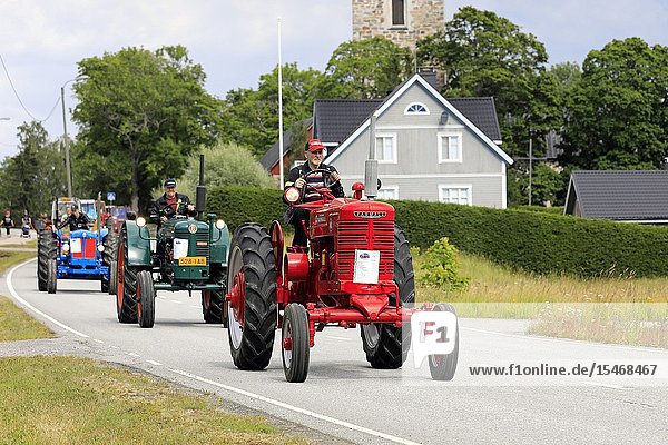 Kimito  Finland. July 6  2019. Vintage tractors  red McCormick Farmall M first  on Kimito Traktorkavalkad  annual vintage tractor show and parade. Credit: Taina Sohlman