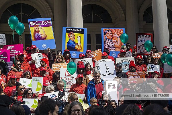 Activists community leaders union members and politicians gather on the steps of City Hall in New York on Tuesday April 2 2019 to rally against pay disparity on the 13th annual Equal Pay Day. Worldwide women on average earn 87 cents for every dollar her male counterpart earns with dramatic adjustments for women of color. The activists besides working for wage parity are calling for action in regards to a salary history ban salary transparency sexual harassment policies and other issues. (© Richard B. Levine).
