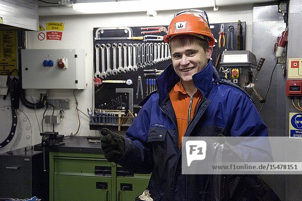 Rotterdam Netherlands. Seaman and ship's engineer maintaining the TugBoat's Taurus engine room and machines.