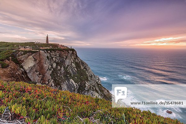 Sunset on the cape and lighthouse of Cabo da Roca overlooking the Atlantic Ocean Sintra Portugal Europe.