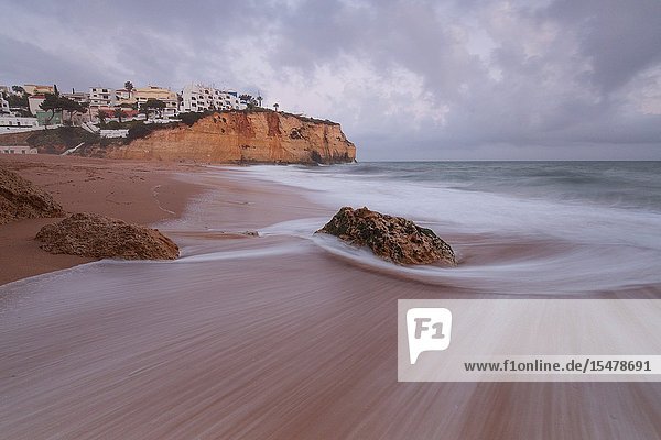 View of Carvoeiro village surrounded by sandy beach and clear sea at dusk Lagoa Municipality Algarve Portugal Europe.