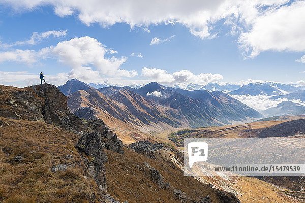 Alpinist in the summit of Punta Valletta Gran San Bernardo Valley Aosta Valley Italian alps Italy.