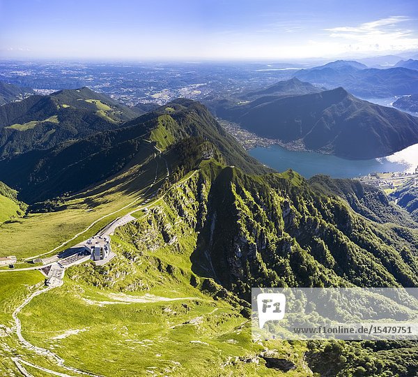 Aerial view of the Monte Generoso and Mario Botta's Fiore di Pietra restaurant on the top of the mountain. Rovio Lake Ceresio Canton Ticino Switzerland.