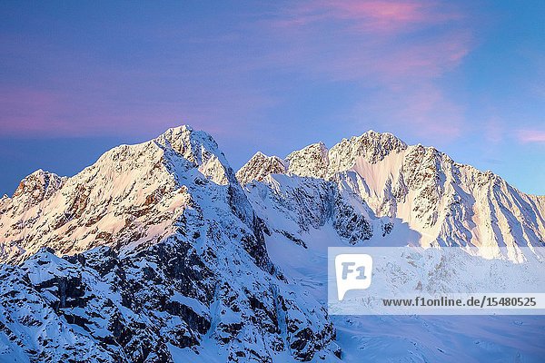 The sun is rising on the north wall of Mount Disgrazia and on Ventina Peak after a copious spring snowfall. Photo shot from Alpe dell'Oro. Province of Sondrio. Valmalenco. Valtellina. Lombardy. Italy. Europe.