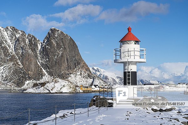 Lighthouse with Festheltinden peak and the village in the background. Reine Nordland county Northern Norway region Norway.