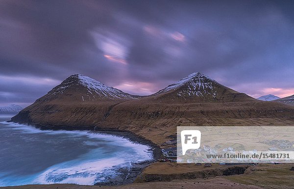 Ocean waves crashing on cliffs around Gjogv Eysturoy island Faroe Islands Denmark.