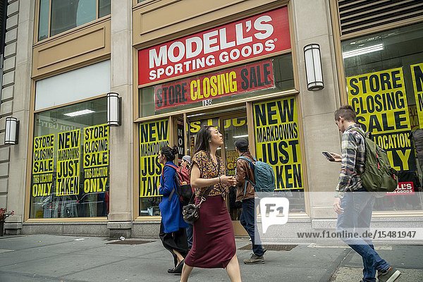 A Times Square location of the family-owned sporting goods chain Modell's is plastered with signs announcing that the store is closing seen in New York on Sunday April 14 2019. Facing pressure from online and big box retailers Modell's Sporting Goods is reported to have hired an adviser on restructuring and a possible bankruptcy. (© Richard B. Levine).