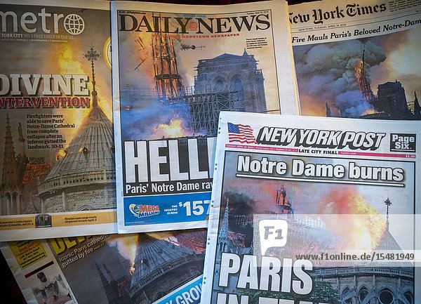 Headlines of New York newspapers on Tuesday April 16 2019 report on the previous day's fire which severely damaged the iconic Notre Dame Cathedral in Paris France. (© Richard B. Levine).