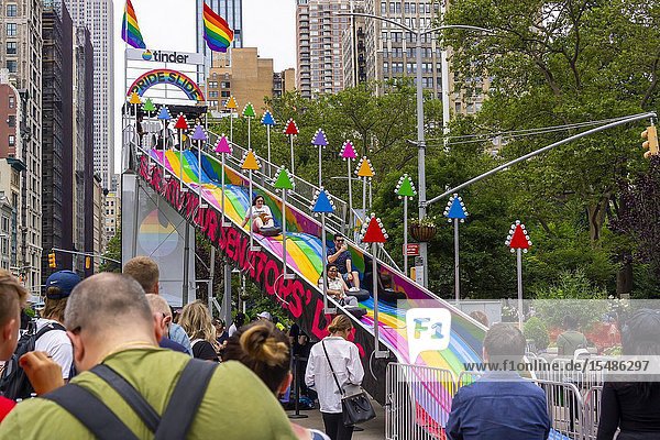 Visitors to Flatiron Plaza in New York on Monday June 24 2019 participate in the dating appâ.s â. œTinder Pride Slideâ.For every ride Tinder will donate $10 to the Human Rights Campaign. Tinder recently released an update to its app that allows users to select up to three sexual orientations including Straight Gay Lesbian Bisexual Asexual Demisexual Pansexual Queer and Questioning. (© Richard B. Levine).